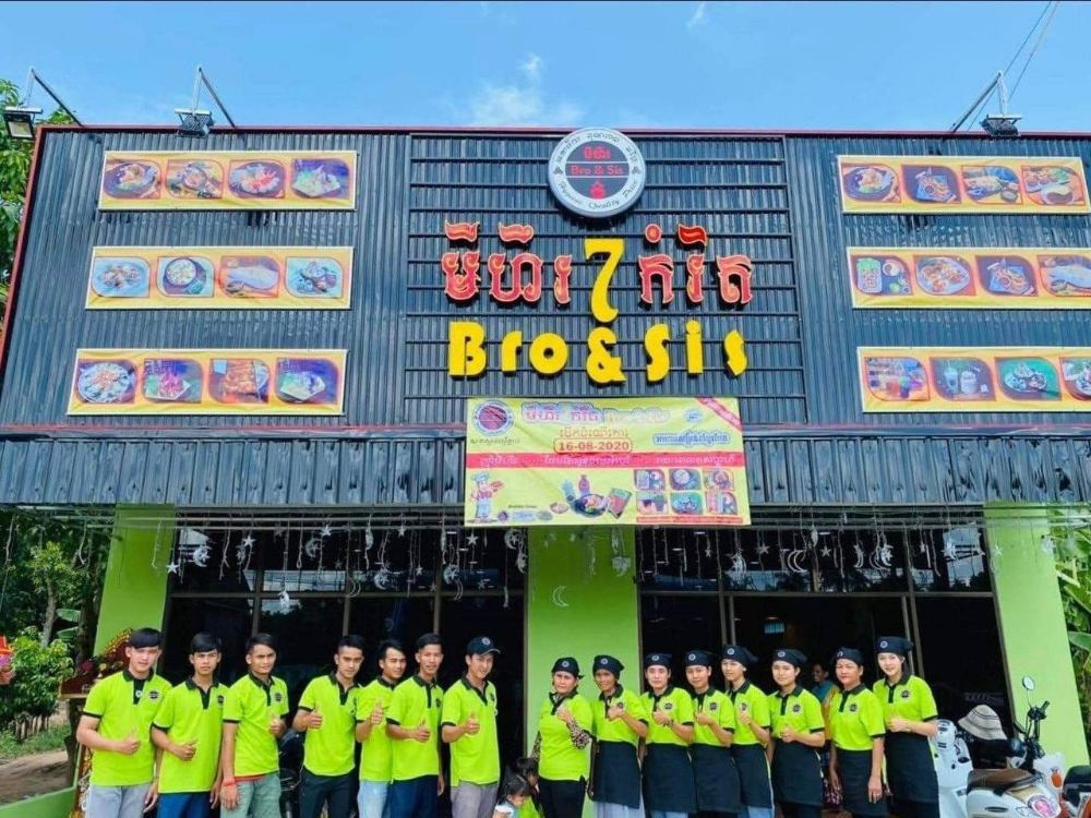 Staff in green uniforms at a branch opening